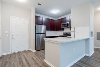A kitchen with a white counter and a stainless steel refrigerator.at Riverview Landing @ Valley Forge, Pennsylvania